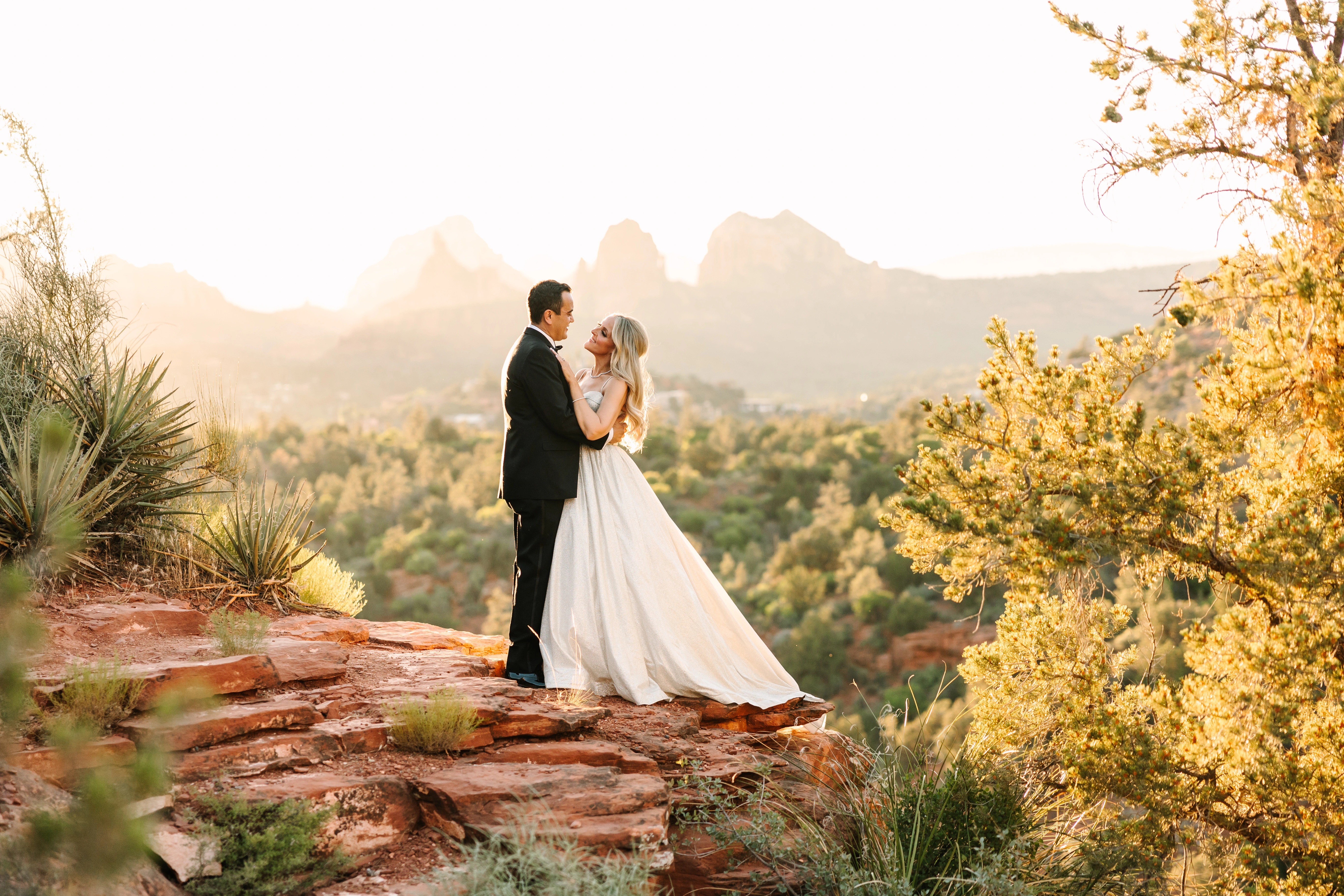 Shana and Kamal overlooking Sedona’s red rocks in golden evening light